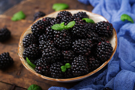 Summer berry on table. Healthy lifestyle concept, blackberries in bowl.